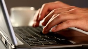 stock-footage-hands-typing-on-a-laptop-keyboard