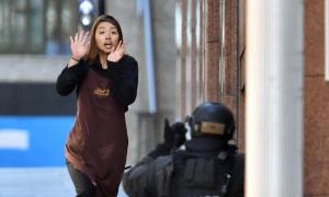 One of the hostages runs towards police