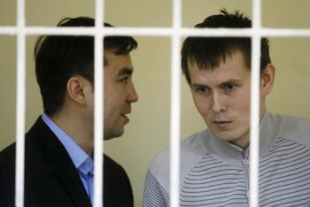 Yevgeny Yerofeyev (L) and Alexander Alexandrov, Russian servicemen arrested last May on terrorism charges related to the separatist conflict in eastern Ukraine, look on from a defendants' cage as they attend a court hearing in Kiev, Ukraine, September 29, 2015. REUTERS/Valentyn Ogirenko/File Photo